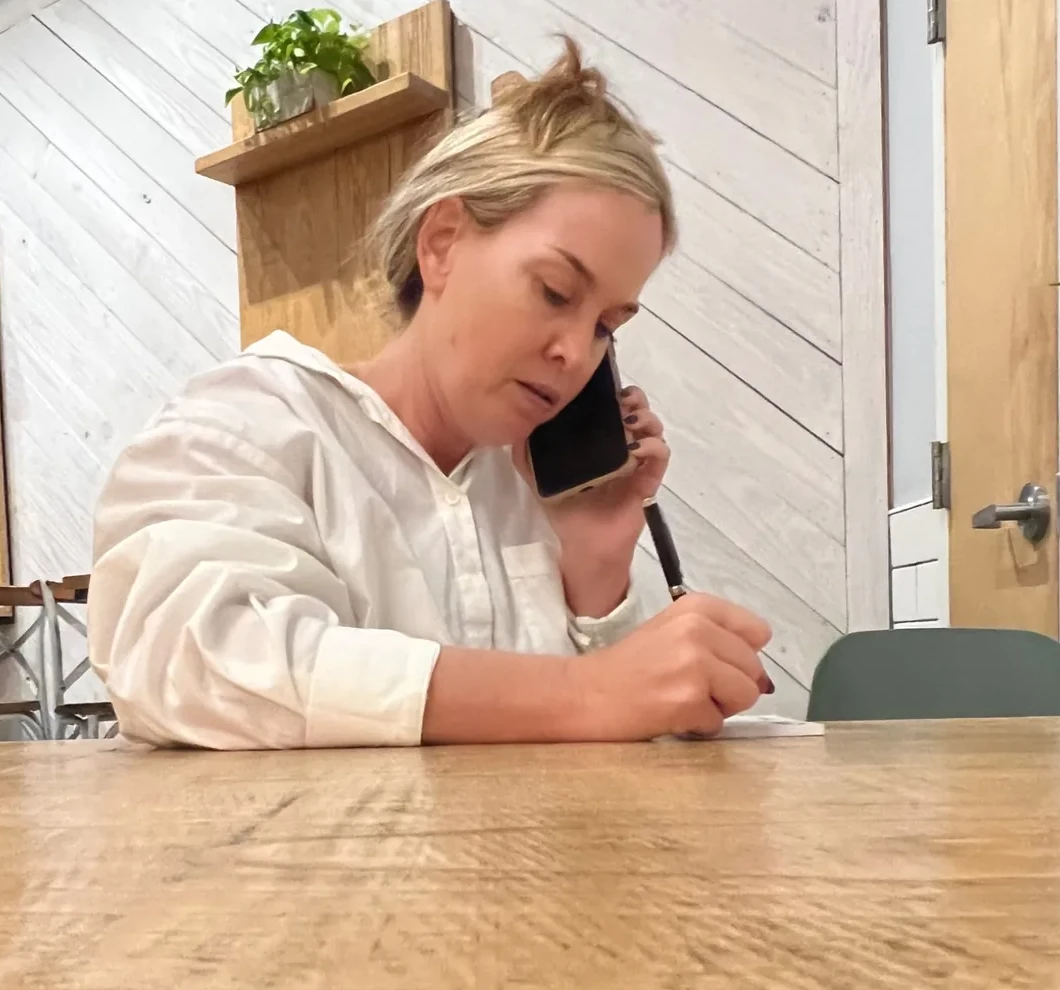 Jessica taking notes while speaking with a client