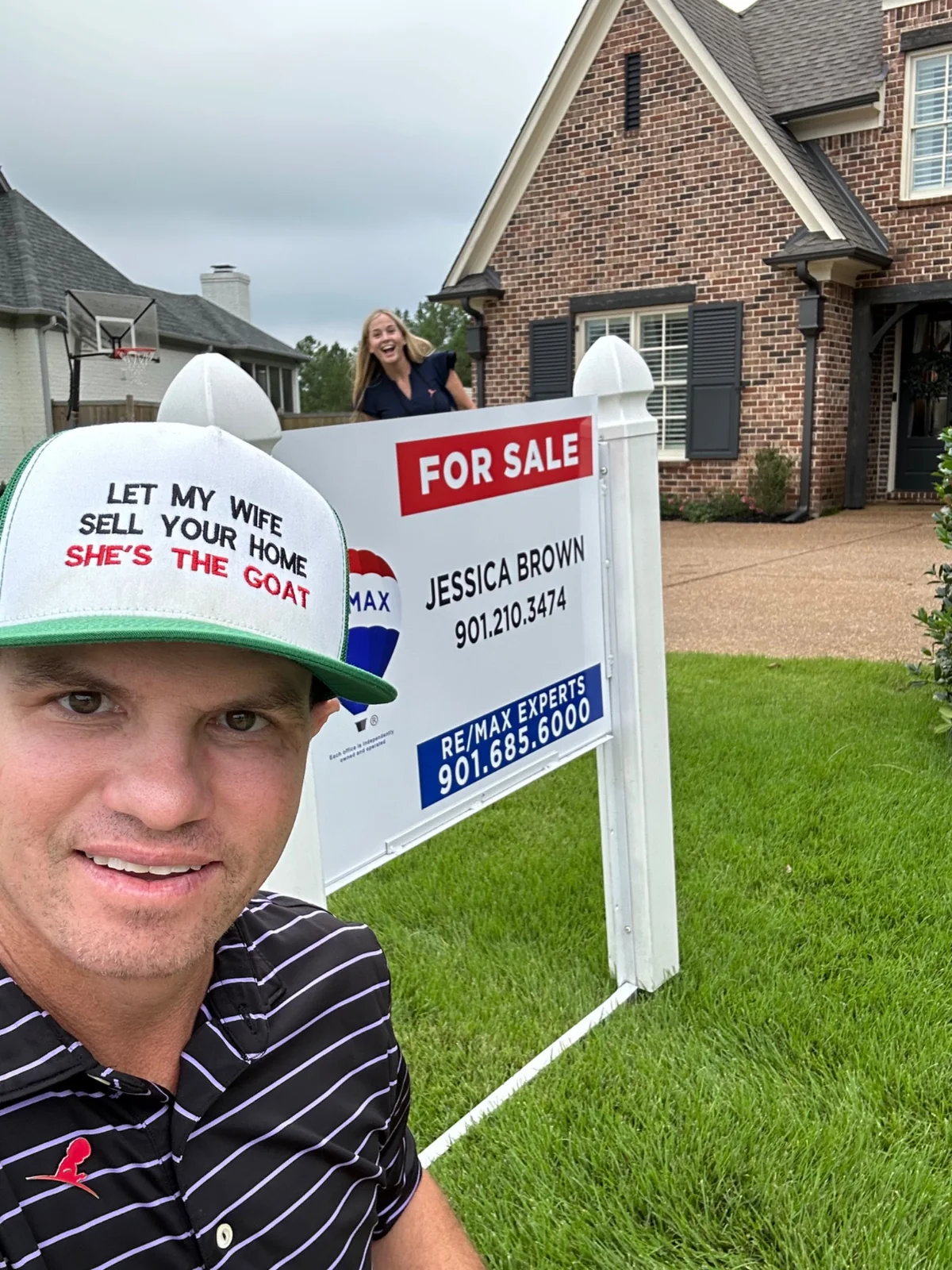 Traynor beside a Jessica Brown RE/MAX Experts real estate sign